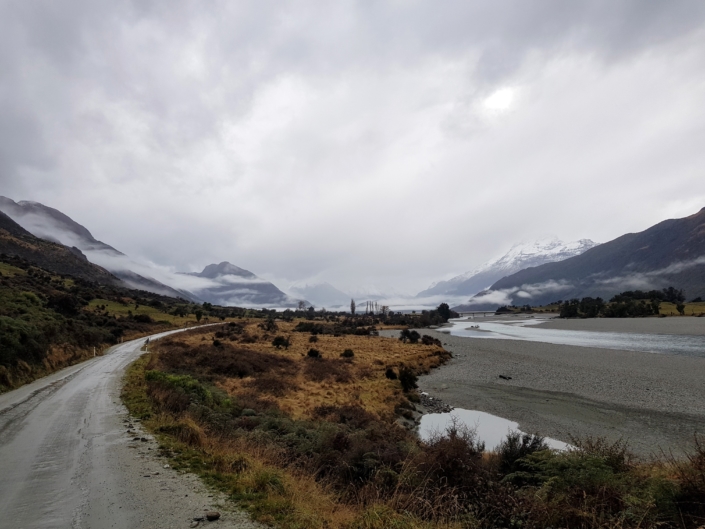 Gravel road from Kinloch to Routeburn with misty mountains