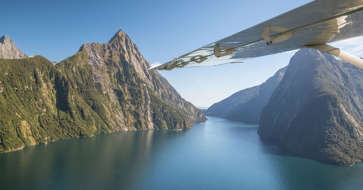 Milford Sound from the air with plane wing across photo