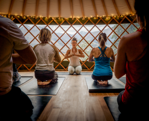 Yoga class in yurt teacher facing camera